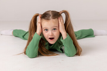 Portrait of little excited shocked crazy smiling girl child kid hold hands isolated on white background