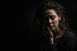 © aicandy - Portrait of a woman in a moment of emotional exhaustion, against a dark, moody studio background, generative ai