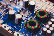 Closeup on electronic board in hardware repair shop, blurred and toned image. Shallow DOF, focus on the middle left field.