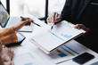 © Parichat - Cropped shot of professional business team working and discussing their recent financial project in the office room.
