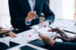 © Parichat - Close up view of businesspeople or accountant team working on financial investment on calculator in the ofiice room.