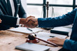 © Parichat - Close up of lawyer shakes hands with client after finish deal, make a deal agreement.