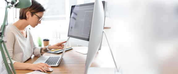 Female programmer working in office. Banner for design