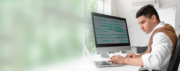 Male programmer working in office. Banner for design