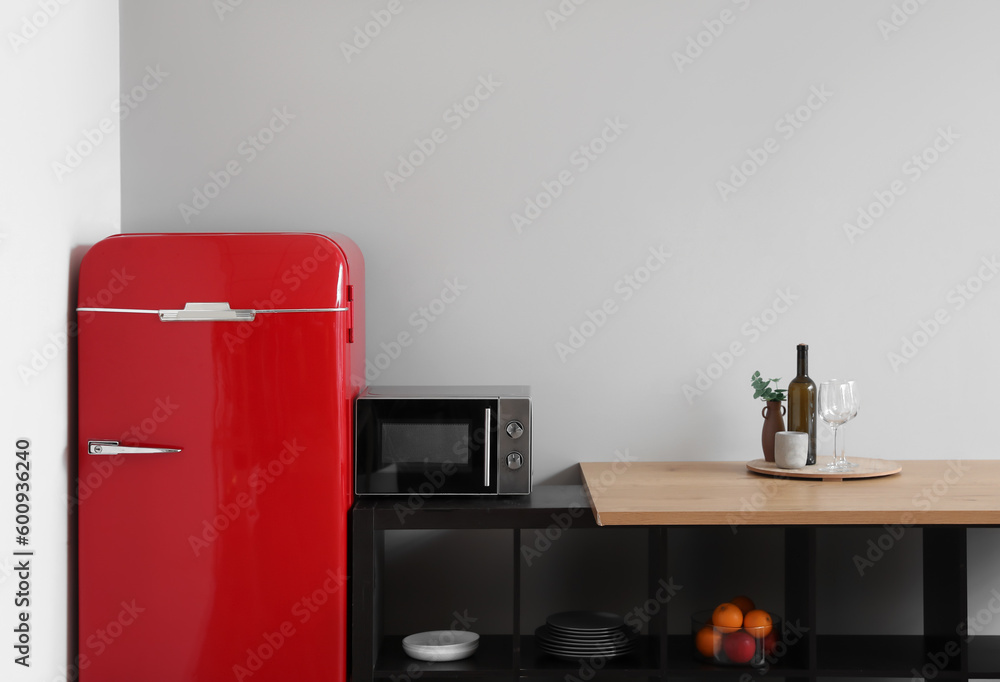 Interior of modern kitchen with stylish refrigerator