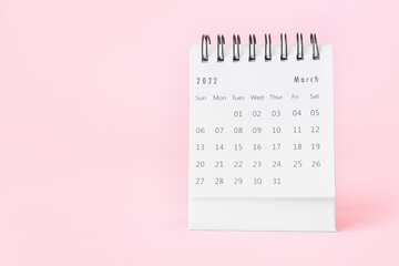 Wall Mural - Flip paper calendar for March on pink background