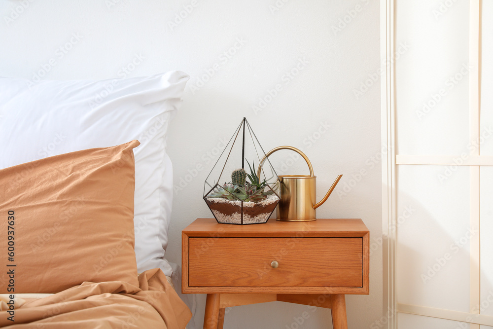 Florarium on table in light bedroom