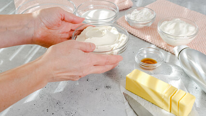 Cheesecake recipe. Ingredients close-up on the kitchen table. Cream cheese, eggs, butter, sugar, crackers, vanilla, yogurt, and corn starch