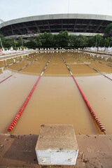 Wall Mural - A olympic swimming pool is seen inundated with flood water in Morumbi neighborhood, Sao Paulo, Brazil, after extreme heavy rains hit the area.