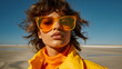 © Ricky - model wearing orange sunglasses on sandy beach with sun and wind, winter fashion editorial made with generative ai