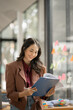 © aekachai - Asian businesswoman sitting and working about documents at the office