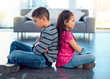 © Thaakirah/peopleimages.com - Angry, brother and sister in home living room, fighting or argument, conflict or problem. Anger, children and kids sitting with arms crossed on floor with their backs together, frustrated and cross.