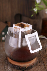 Poster - Coffee in a drip-pack in a transparent mug