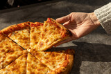 Fototapeta Kawa jest smaczna - Hand taking four cheese pizza slice