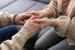 © Angelov - Young woman holding senior man hands, closeup