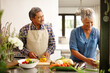 © Laflor/peopleimages.com - Food, elderly couple and cooking while happy in kitchen of their home. Teamwork or help, vegetables and senior married people preparing a meal for dinner or lunch together in their house.