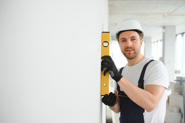 Wall Mural - A happy worker proudly standing at his workplace.