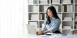© crizzystudio - copy space, panorama, banner Modern working lifestyle Asian businesswoman sits at desk with laptop online using internet and notepad happily recording receipt contact information online delivery.