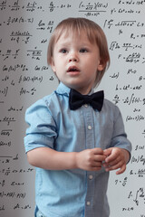 Wall Mural - Portrait of the little boy in the blue shirt over the math background, high IQ, mathematical mindset, child prodigy