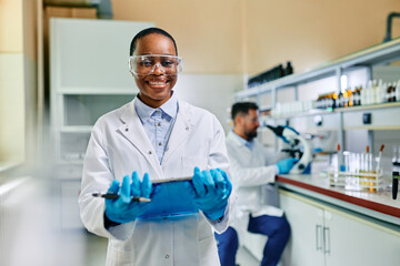 Wall Mural - happy black female scientist in laboratory looking at camera.
