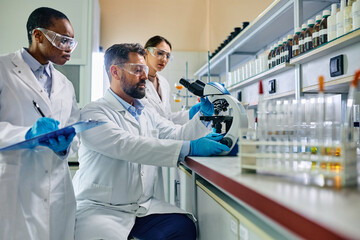 Wall Mural - multiracial team of scientists working on research in laboratory.