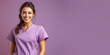Leinwandbild Motiv Attractive woman wearing medical scrubs, isolated on purple background. Place holder, copy space banner for medical  and beauty industry