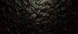Abstract coal background with lava gaps between the stones.