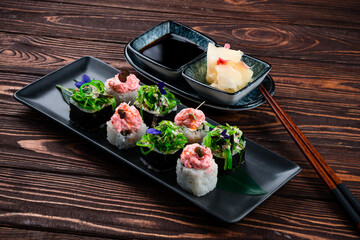 Canvas Print - Japanese sushi roll set with salmon, tuna, cucumber, Philadelphia cheese, algae and microgreens.