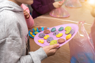 Wall Mural - colorful dumplings on a paper plate in a child's hand. master class manual molding