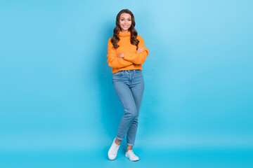 Wall Mural - Full length photo of positive confident lady dressed orange pullover arms crossed isolated blue color background