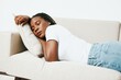 © SHOTPRIME STUDIO - Happy african american woman sleeping at home on the sofa, rest and vacation smile, light background, daytime sleep, fatigue depression. Relaxed home lifestyle, day off.