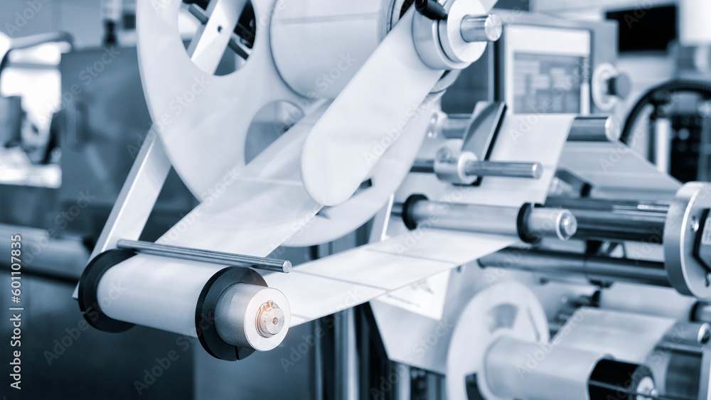 Fragment of the conveyor of sticking labeling machine. Abstract industrial background.