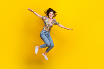 Canvas Print - Full body size photo of attractive young woman flying hands wings crazy emotions traveler explore world isolated on yellow color background