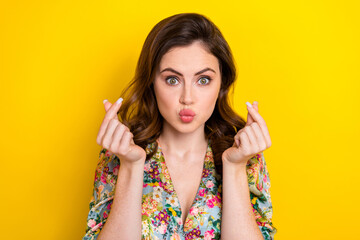 Poster - Portrait of stunning lady pouted lips kiss arms fingers demonstrate korean love gesture isolated on yellow color background