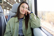 © ADDICTIVE STOCK - Happy pensive woman looking away in bus