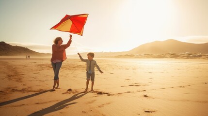 Wall Mural - Mother and son playing with kite on sunny beach