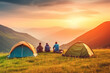 © ADDICTIVE STOCK - Generative AI illustration of anonymous group of friends camping at campsite with tent watching sunrise in mountains