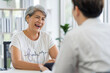 © SKW - Asian seniors who are healthy, in a good mood, smiling, talking with financial or life insurance staff to take care of life after retirement...