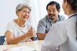 © SKW - Asian seniors who are healthy, in a good mood, smiling, talking with financial or life insurance staff to take care of life after retirement.