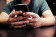 © Charlie's - Cropped view of male hands holding cell phone with blank screen.Man using electronic gadget, typing message or checking newsfeed on social networks.