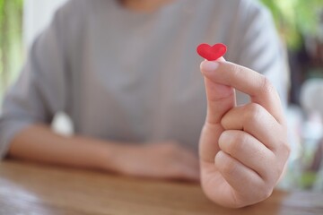 Woman hands making mini Heart and small heart. Valentine Love symbol.