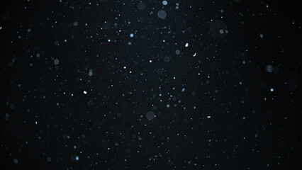 white snow falling on an isolated black background, bokeh of flying snowflakes, dust particles or po