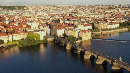 Poster - Prague Old Town in Czech Republic with Famous Sightseeing Places in Background. Charles Bridge Iconic 14th century Structure with View, Vltava river and Prague Cityscape. Must Visit City. Drone, 4k