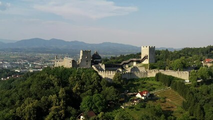 Poster - Celje Castle is a castle ruin in Celje, Slovenia, formerly the seat of the Counts of Celje. It stands on three hills to the southeast of Celje, where the river Savinja meanders into the Lasko valley