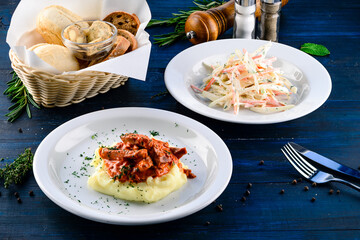 Canvas Print - Beef goulash with sauce, mashed potatoes with salad of cabbage, carrots and greens.