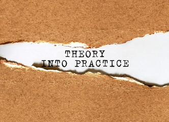Wall Mural - Text Theory into Practice appearing behind torn brown paper