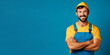 Handsome male model wearing baseball cap and dungarees on solid color background Banner for handyman, contractor, plumber, electrician, architect etc.