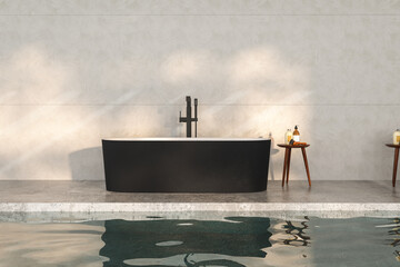 A modern bathroom with a black tub standing on a concrete floor, complete with a faucet, a small table with liquid soap next to it, and a sunlit concrete wall in the background and pool. 3d rendering