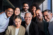 © Gigi Delgado - Cheerful portrait of a group of business colleagues taking a photo for the company page in the office, gathered looking at camera smiling, headed by the boss. Startup concept.