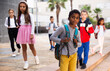 © JackF - Portrait of african american boy standing near school, children on background